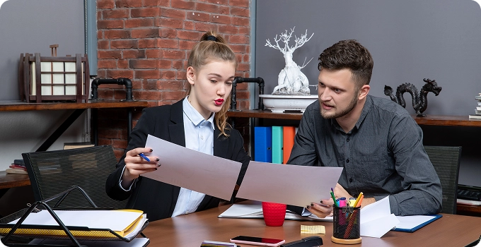 top view young busy motivated clerical workers discussing one issue documents office
